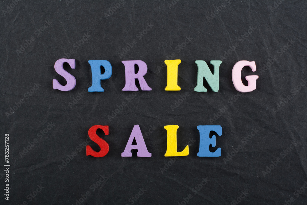 Spring sale word on black board background composed from colorful abc alphabet block wooden letters, copy space for ad text. Learning english concept. Spring sale word on black board background composed from colorful abc alphabet block wooden letters, copy space for ad text. Learning english concept.