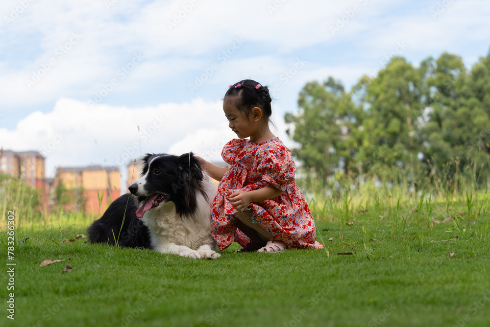 lovely asian baby girl sitting on the dog lovely asian baby girl sitting on the dog