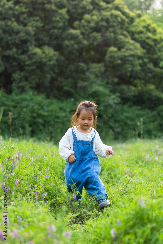 adorable asian kid in spring field