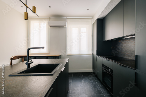 Modern and elegant kitchen interior decorated in dark tones photo