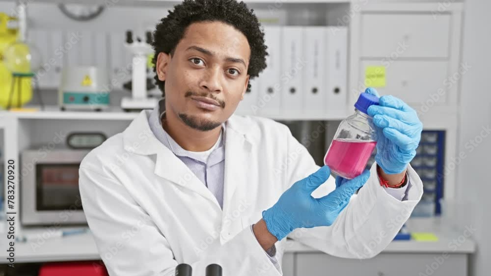 Confident male scientist examines a pink liquid in a laboratory setting, embodying professionalism and expertise. Confident male scientist examines a pink liquid in a laboratory setting, embodying professionalism and expertise.