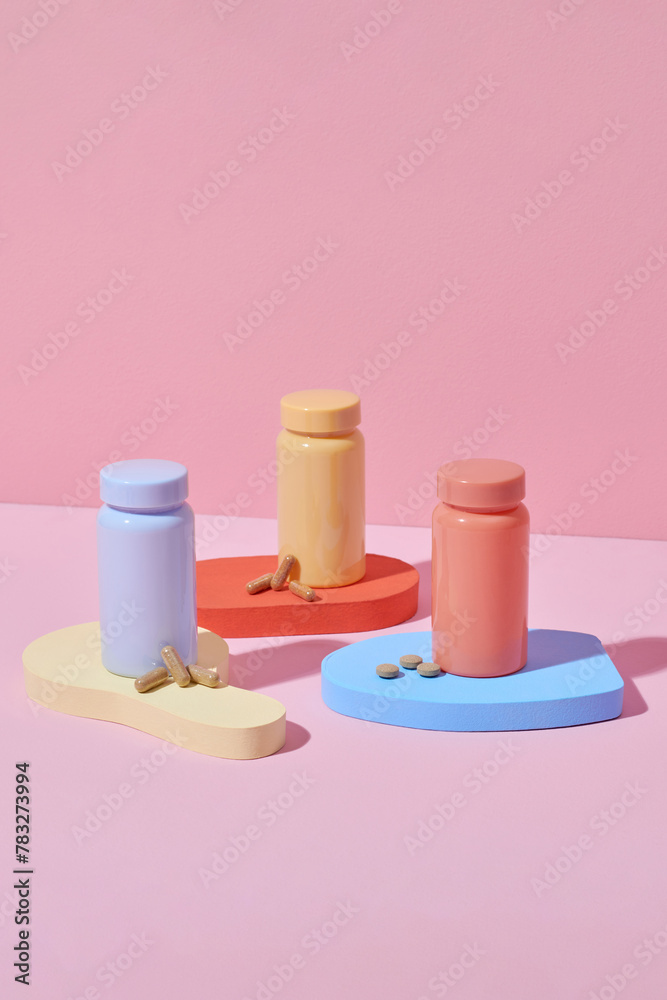 Medical still life with three pills bottles on color podium Medical still life with three pills bottles on color podium