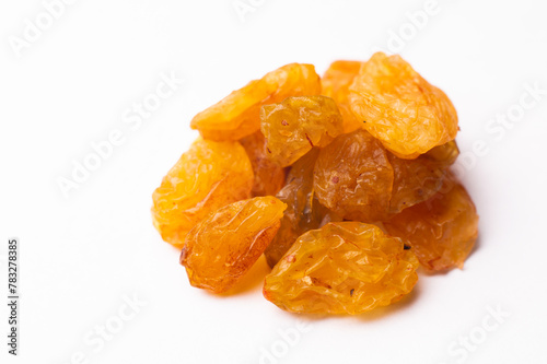 Raisins lie in a pile on a white background, close-up of the texture of the raisins, macro shot