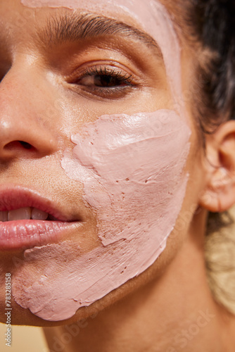 Woman with pink clay face mask 
