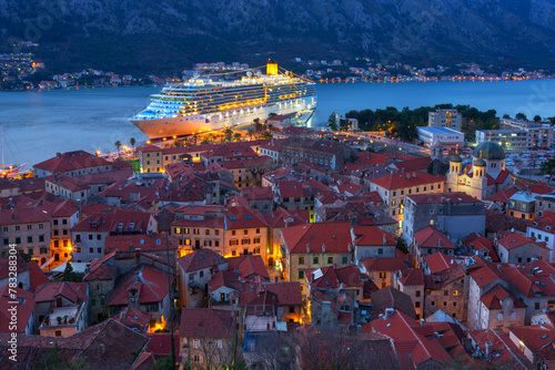 Top view of the old town in Kotor and a big cruise ship at night, Montenegro