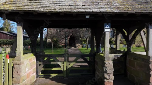 Drone flying through the outer gate of St John the Evangelist's Church, Toft, Cheshire, England, UK photo