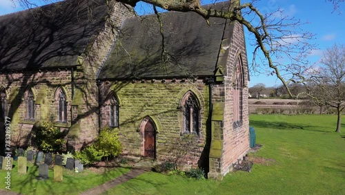 Drone shot of St John the Evangelist's Church in Toft Road, Toft, Cheshire, England, United Kingdom photo