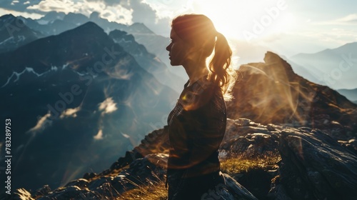 The picture of the young or adult female human doing the standing pose for relaxation or meditating the mind in the middle of the nature under bright sun in the daytime of a dawn or dusk day. AIGX03. #783289753