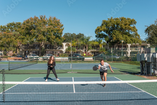 Couple on a court playing pickleball