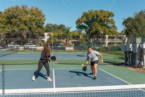 Couple playing pickleball