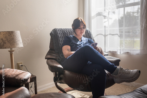 Nurse at home checking messages photo