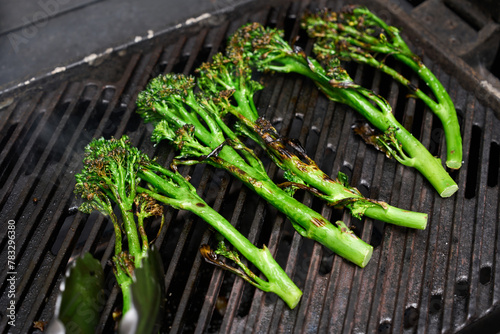 Chargrilling broccolini on barbecue photo