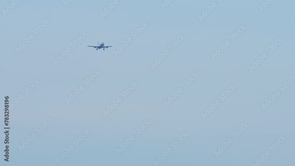 Commerical airplane is approaching landing, descending, arriving. Long shot, jet plane in the sky. Concept travel and tourism Commerical airplane is approaching landing, descending, arriving. Long shot, jet plane in the sky. Concept travel and tourism