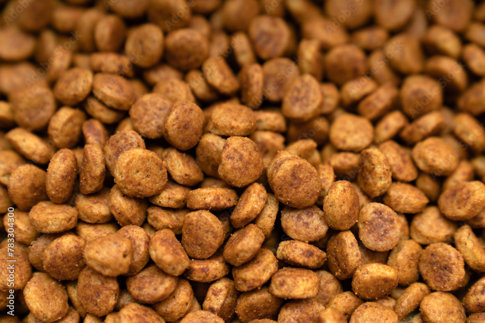 Food for animals background. Dry cat and dog food texture, pattern. Pet meal background close up. Dry food for pet dogs and cats. Dried pet food top view. Granules of good nutrition for dogs and cats. Food for animals background. Dry cat and dog food texture, pattern. Pet meal background close up. Dry food for pet dogs and cats. Dried pet food top view. Granules of good nutrition for dogs and cats.