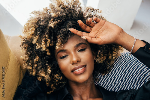Serene afro woman with curly hair enjoying a peaceful moment photo
