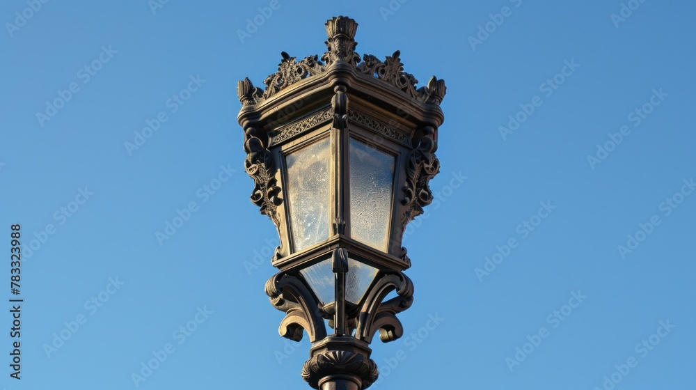 Vertical low angle shot of an old-fashioned traditional street lamp on a sunny day with a clear blue sky in Lisbon