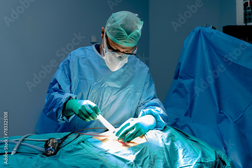 The surgeon prepares for laparoscopic surgery inside the camera and laparoscopy tip by cutting the patient's abdomen with a scalpel. Operation using laparoscopic equipment. Minimally invasive surgery