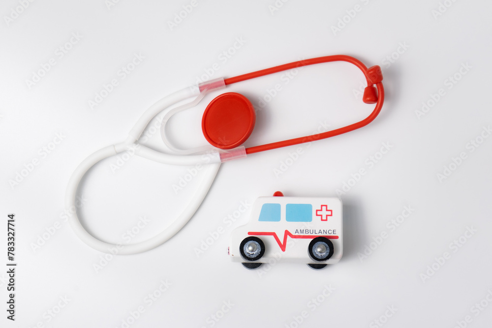 wooden ambulance toy car and stethoscope isolated on white background wooden ambulance toy car and stethoscope isolated on white background