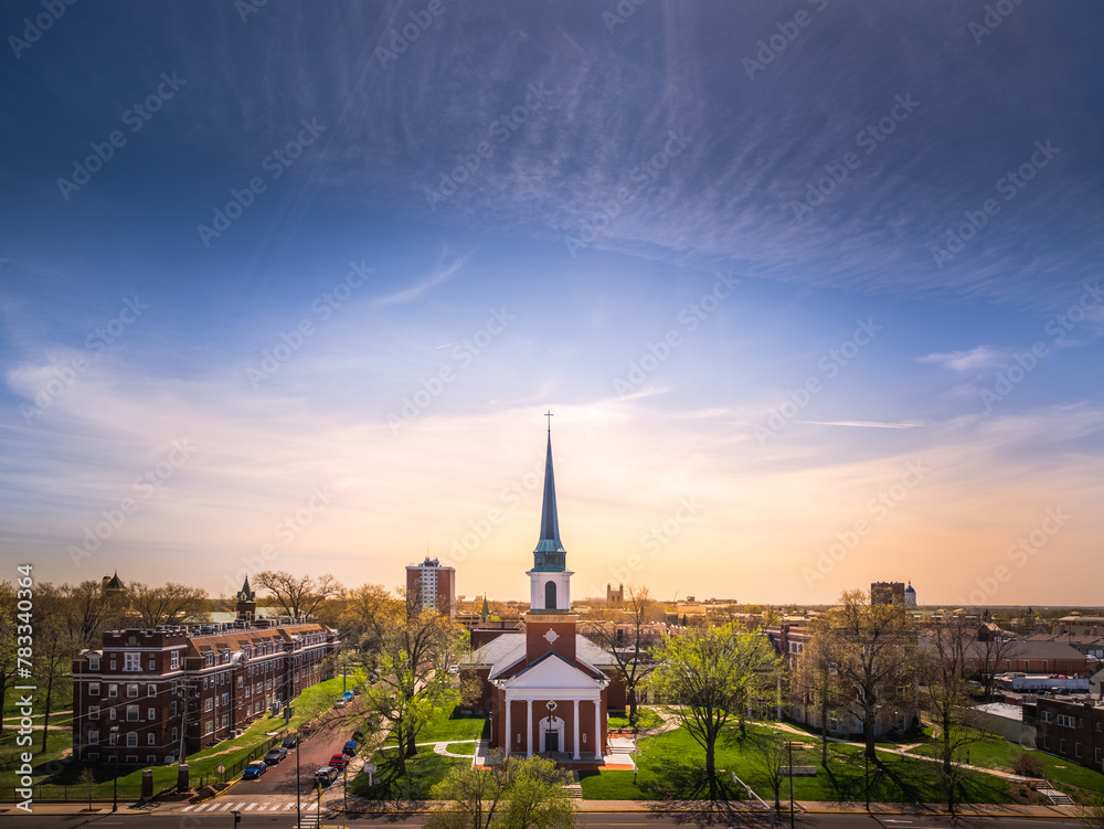 Fototapeta premium Beautiful view of Midwestern town at sunset in spring; sunset sky in background