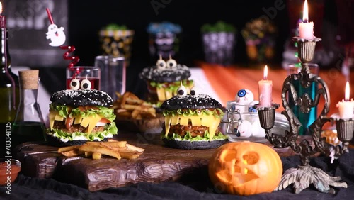 The witch opens the bottle and pours an orange drink into a glass. Festive table Halloween party. Movement from right to left. Real time.