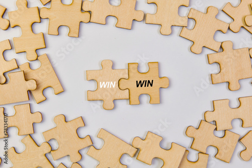 Jigsaw puzzle pieces with the word win business success concept