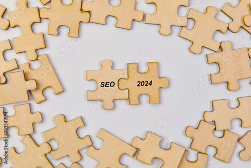 Wooden puzzle pieces with word SEO 2024 Business concept image