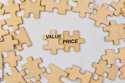 Wooden puzzle pieces with word Value Price Business concept image