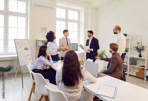 Delegation of specialists in office actively conducts dialogue, exchanging ideas and strategies. Business team meeting where professional participants share and listen, exchanging ideas and plans.