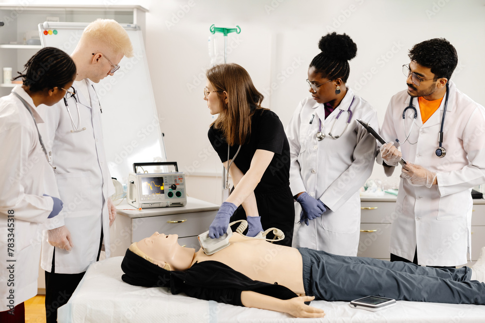 Instructor teaching first aid cardiopulmonary resuscitation course and use of automated external defibrillator workshop - obrazy, fototapety, plakaty 