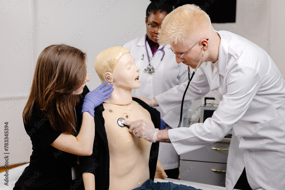Fototapeta premium Female doctor examining male mannequin