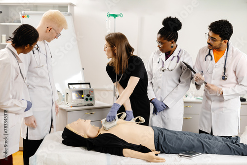 Instructor teaching first aid cardiopulmonary resuscitation course and use of automated external defibrillator workshop photo