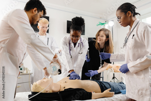 Medical personnel demonstrating cpr on dummy photo