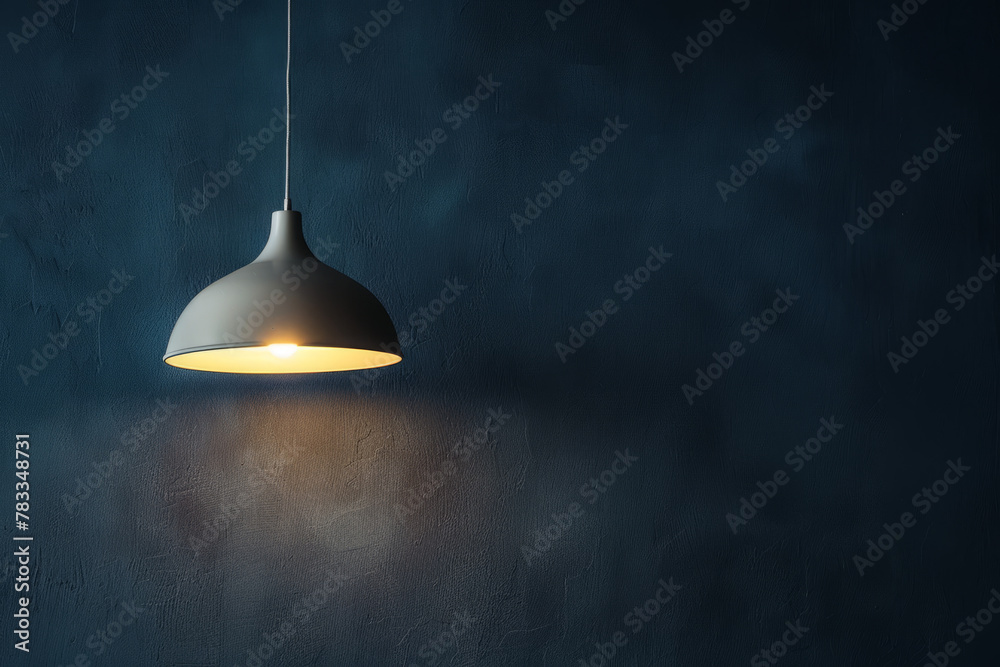 A lamp hangs against a dark wall, casting its light and illuminating the area, with space available for text or presentation. A lamp hangs against a dark wall, casting its light and illuminating the area, with space available for text or presentation.