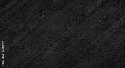 close up view of dark black wood texture. wood grain background in diagonal pattern. oblique wooden pattern background with blank space for design. photo