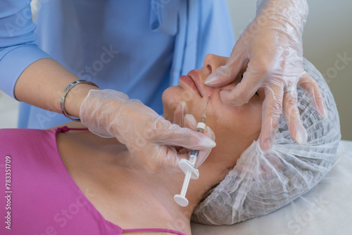 Medical professional administers a precise injection, a common aesthetic procedure. This represents the attention to detail in modern cosmetology.