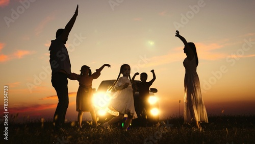 Family party in nature by car, children kids parents dancing together enjoying summer time fun company. Kids sons daughters mom dad having good time with music by car big family travelling road trip