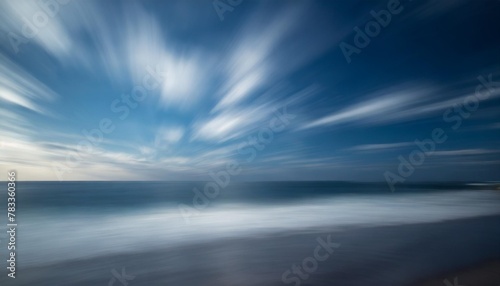 abstract motion blur background of the sea with blue sky and clouds