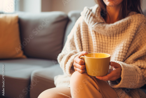 A cozy winter morning with a woman holding a hot cup of tea, enjoying a moment of leisure.