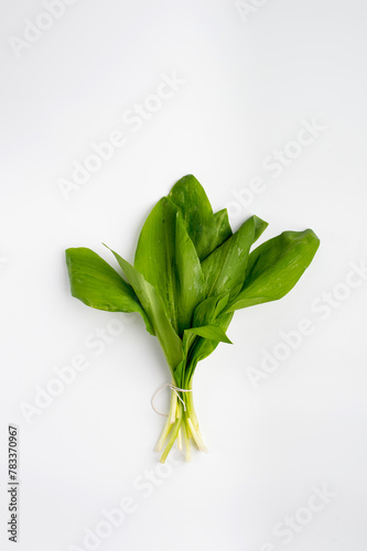 A bunch of wild garlic on a light background, top view. Ramson.