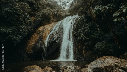 a waterfall in the middle of a tropical forest