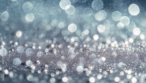 beautiful festive background image with sparkles and bokeh in pastel pearl and silver colors selective focus shallow depth of field