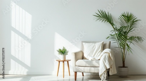 Ideas for modern minimal home interior design. Gray vintage armchair with white pillow and blanket, table with green plant in pot on floor, on light wall background, panorama, copy space, nobody © buraratn