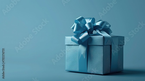 Part of Luxury gift box with a blue bow on blue. side view monochrome. Fathers day or Valentines day gift for him. Corporate gift concept or birthday party. Festive sale wide banner