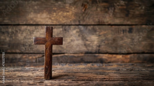 Religious crucifix cross upright on wooden table background with copy space