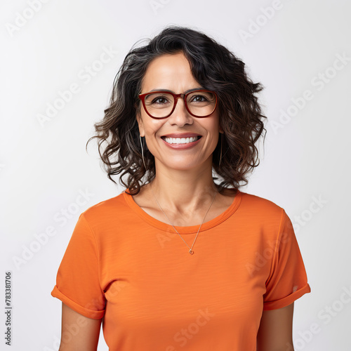 A woman wearing an orange shirt and glasses is smiling. She is wearing a necklace and has her teeth showing