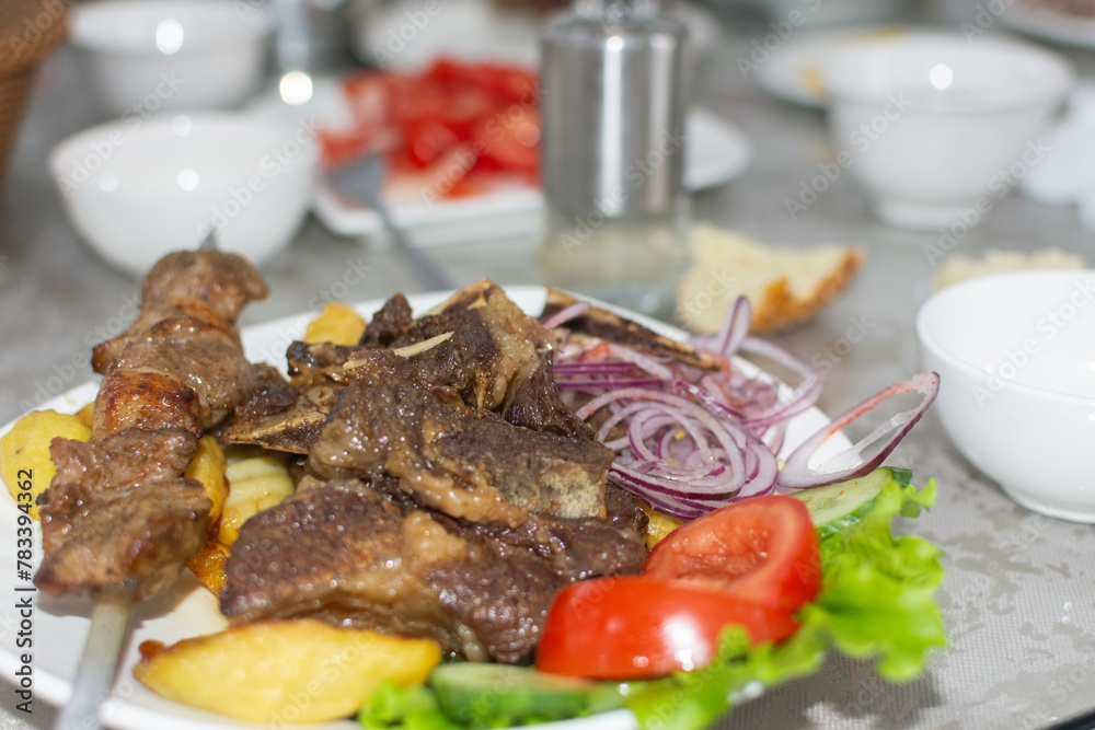 meat and potatoes garnished with vegetables meat and potatoes garnished with vegetables