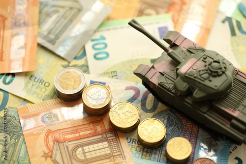 Many euro banknotes and tank. Lot of bills of European union currency and green tank close up © mehaniq41
