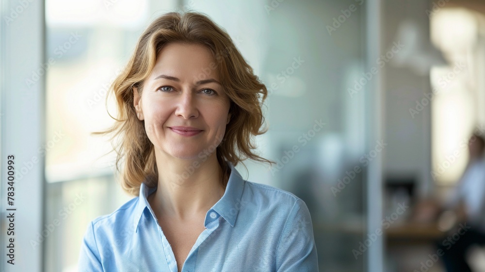 Smiling business woman in a blue shirt