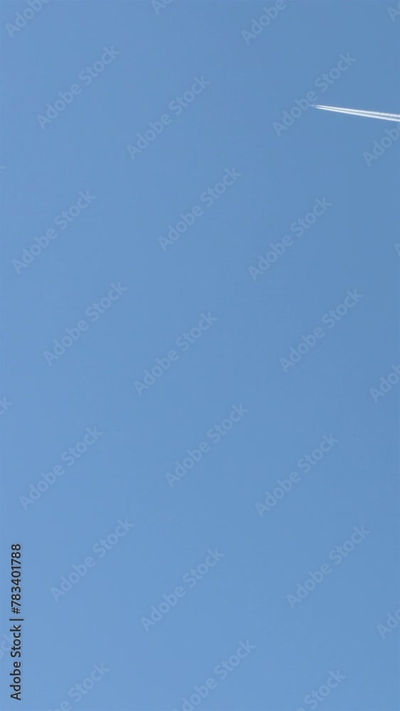 Airplane Contrail Streaking Across The Sky. Vertical
Airplane Contrail Streaking Across The Sky. Vertical