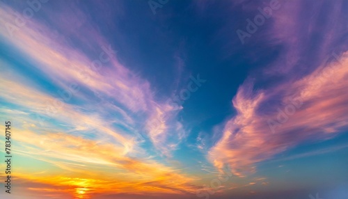 vivid sky color background abstract wispy gold purple pink blue green yellow red and orange sunset colors in cloudy artistic pattern fun colorful background